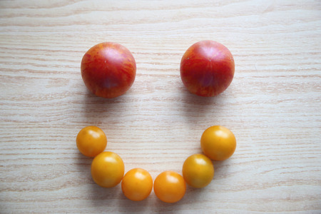 Top view of fresh tomatoes on the table with wood texture. Smileの写真素材