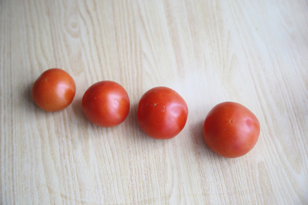 Top view of fresh tomatoes on the table with wood texture. Smileの写真素材
