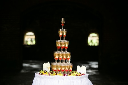 Glasses of champagne pyramid made up with fruitsの写真素材