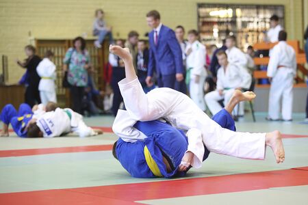fighter judo in competition in white kimonoの写真素材