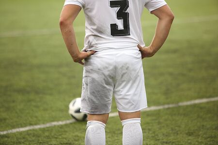 Football player with ball in white shorts and t-shirtの写真素材