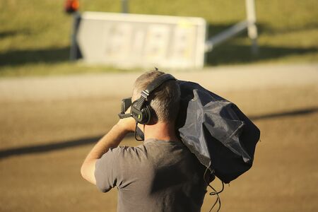 he cameraman in dust shoots a sport reportの写真素材