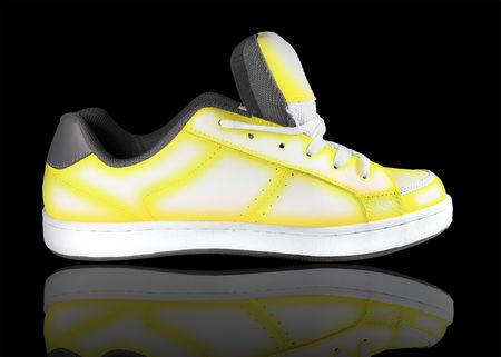 yellow-white sneaker on a black backgroundの写真素材