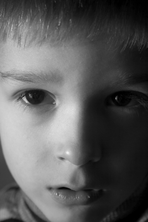 sad child in the shadeの写真素材