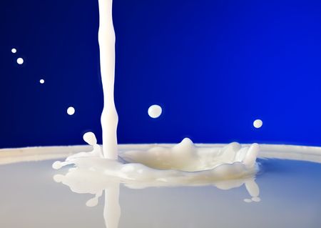 the process of pouring milkの写真素材