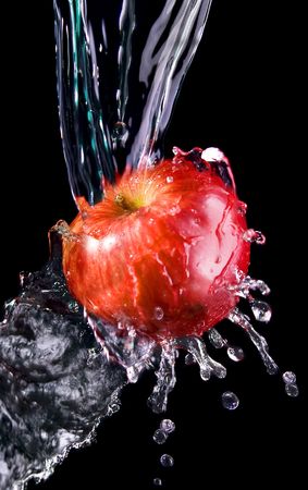 Apple in water on a black backgroundの写真素材