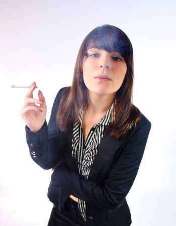 Woman in a suit smoking a cigaretteの写真素材
