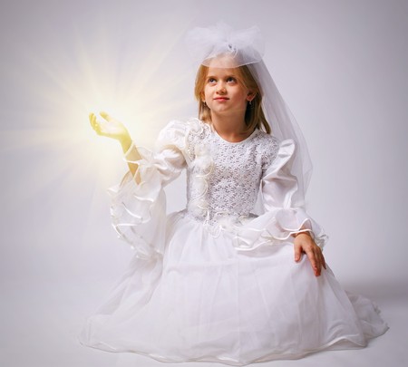 The little girl in a dress of the bride, studio shotの写真素材