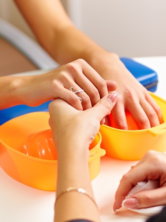 Young woman getting a manicure in a nail salon.の写真素材