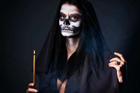 Gothic portrait of dead woman with candleの写真素材