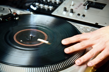 DJ's hand spinning vinyl record