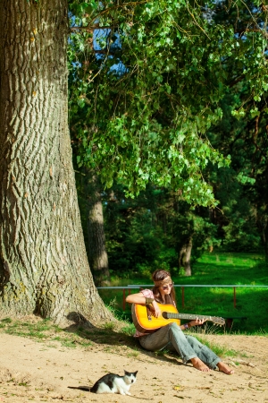 Beautiful hippie girl with guitarの写真素材