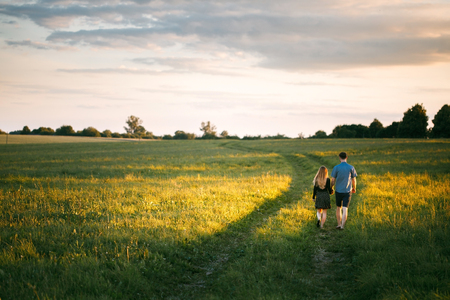 Romantic love story. Young couple at sunsetの写真素材