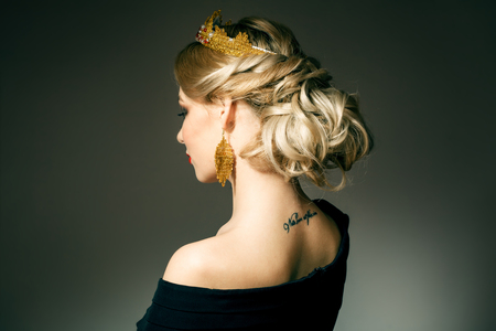 Beautiful blonde girl with a golden crownの写真素材