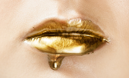 Gold lip gloss. Cosmetics and make-up.の写真素材