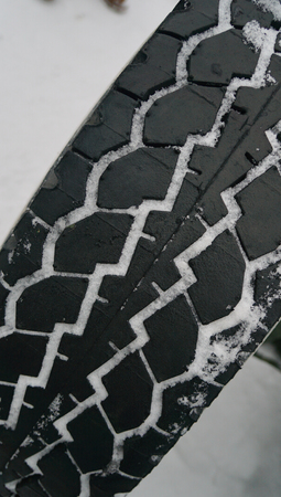 Car tire background with snow. Tyre texture closeup backgroundの写真素材