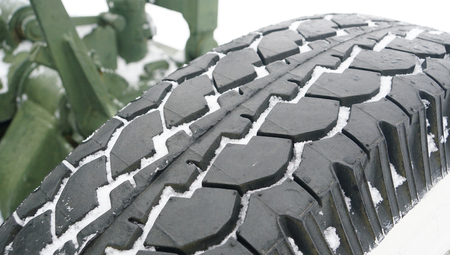 Car tire background with snow. Tyre texture closeup backgroundの写真素材