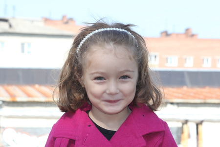 Portrait of happy smiling cute little girl child outdoors in summer dayの写真素材