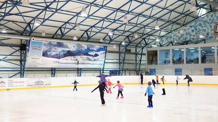 Moscow,Russia - February 09, 2019. Female coach in figure skating training little girl in black tights at indoor rinkのeditorial素材