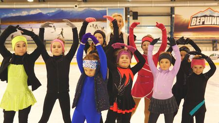 Moscow,Russia - February 09, 2019. Female coach in figure skating and her liitle students at indoor rinkのeditorial素材