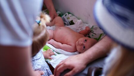 Rite of the baptism of the little boy in the Christian tradition. Boy waiting the start of a ceremonyの写真素材