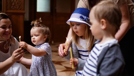 Little children taking the candles, first visit and first impression in a Churchの写真素材