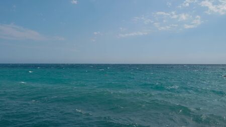 Calm Sea Ocean with little swimmer head And Blue Sky Backgroundの写真素材