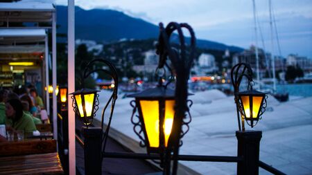 Retro street lamsp shining at dusk in a cafe in the Crimean Yalta