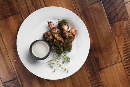 Chicken wings barbecue in a white plate.の写真素材