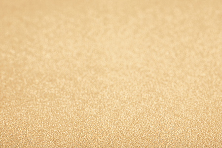 Golden (yellow) glitter background. Sparkle texture. Abstract background blurred for New Years or Christmas holidayの写真素材