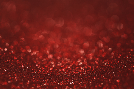 Dark red (ruby) glitter background. Sparkle texture. Abstract gradient background blurred for New Years or Christmas holidayの写真素材