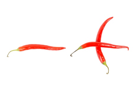Three red hot chilli, chili, or cayenne peppers isolated on a white background arranged as a plus and minus signの写真素材