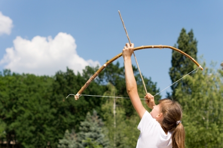 Girl is aiming her arrow at the sky