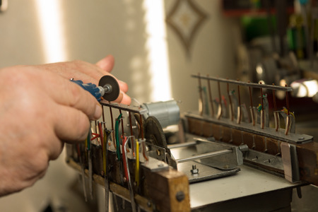 Model builder working with his scaled down equipment suited to the precision he requires with a...