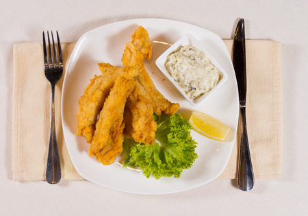 Gourmet Tasty Fried Meaty Main Dish with Creamy Dip Served on White Table with Utensils on Both...