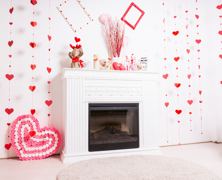 Modern Fireplace Mantle in White Room Decorated for Valentines Day with Heartsの写真素材