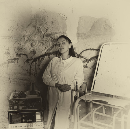 Ghostly monochrome image of a woman in front of a blood splattered wall with the serene expression of psychosis, Halloween conceptの写真素材