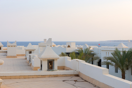 Roof of white houses in ?rabic style, background  clear blue sky and seaの写真素材
