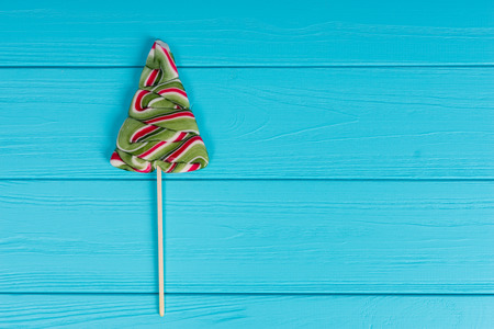 Tasty lollipop as a Christmas Tree on wooden turquoise boardの写真素材