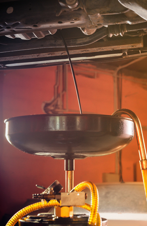 Modern equipment for changing motor oil in automobile engine in a car workshopの写真素材
