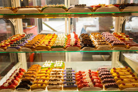 Countertop with confectionery appetizing products, delicious with various fillings eclairs, food and beverage conceptの写真素材