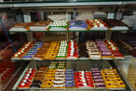 Countertop with confectionery products, delicious with various fillings eclairs, food and beverage...