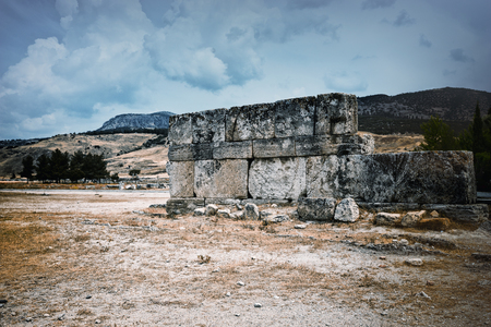 Mountainous landscape in Anatolia, Turkey with the ancient ruins of the Greek spa resort of Hierapolis near the hot springs at Pamukkaleの写真素材