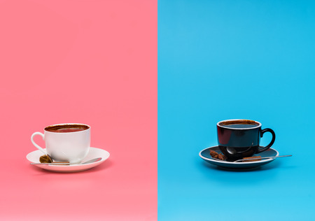 Two cups of coffee on pink and blue backgroundの写真素材