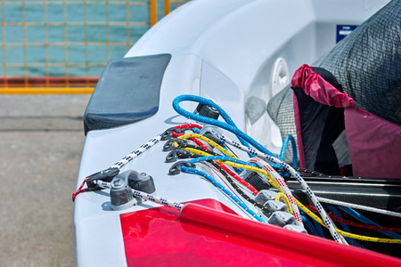 Carefully laid ropes on board the boat on the pier on a sunny day