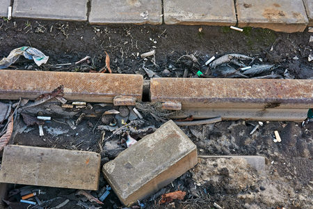 Old rusty rails in the garbage in the cityの写真素材