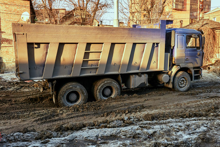 A big dirty truck is in the city on a construction siteの写真素材