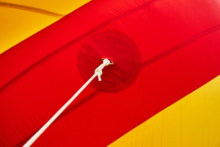 The metal holder for the rope is sewn to the red fabric with threadsの写真素材