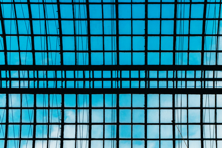 Glass ceiling overlooking the blue sky in a large shopping center and office building in a big cityの写真素材