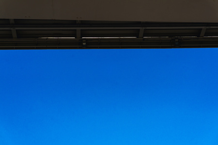 Smooth edge of a new metal bridge against a blue clear sky